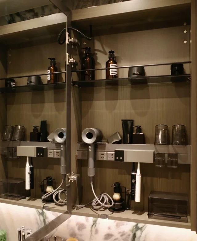 Hotel bathroom vanity featuring floating design with concealed lighting, integrated drawer power outlets, soft-close drawers, and ample counter space for a premium, guest-friendly experience.