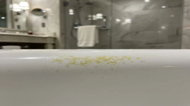 Yellowed bathtub surface caused by material aging and oxidation, illustrating why cleaning alone cannot restore whiteness