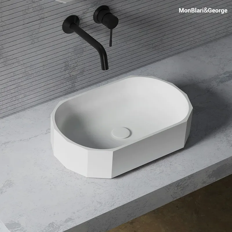 Architectural faceted basin silhouette that interacts with bathroom lighting to create a dynamic visual statement.