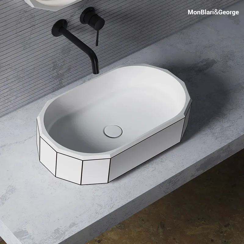 Close-up of a hand-polished solid surface sink featuring a velvety matte finish and seamless non-porous texture.