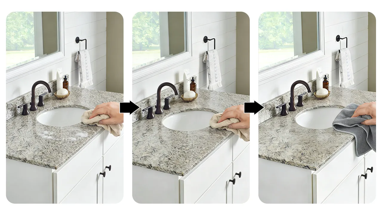 Hotel housekeeping staff following a daily cleaning protocol by wiping a granite vanity with a soft cloth and warm soapy water.