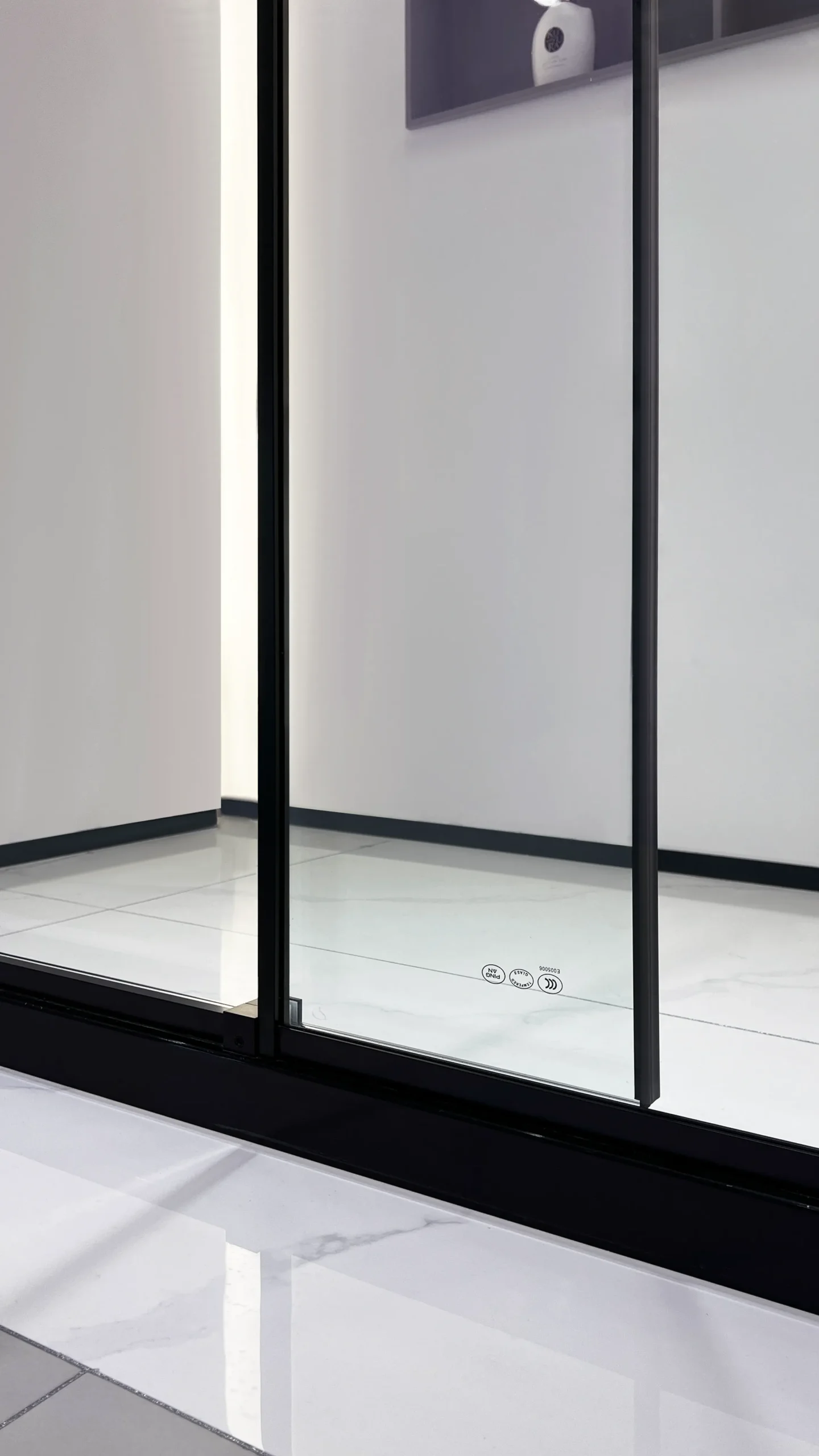 Matte black sliding glass shower door with fixed panel, showing soft-close dampers and quiet rubber pulley for smooth, silent operation.