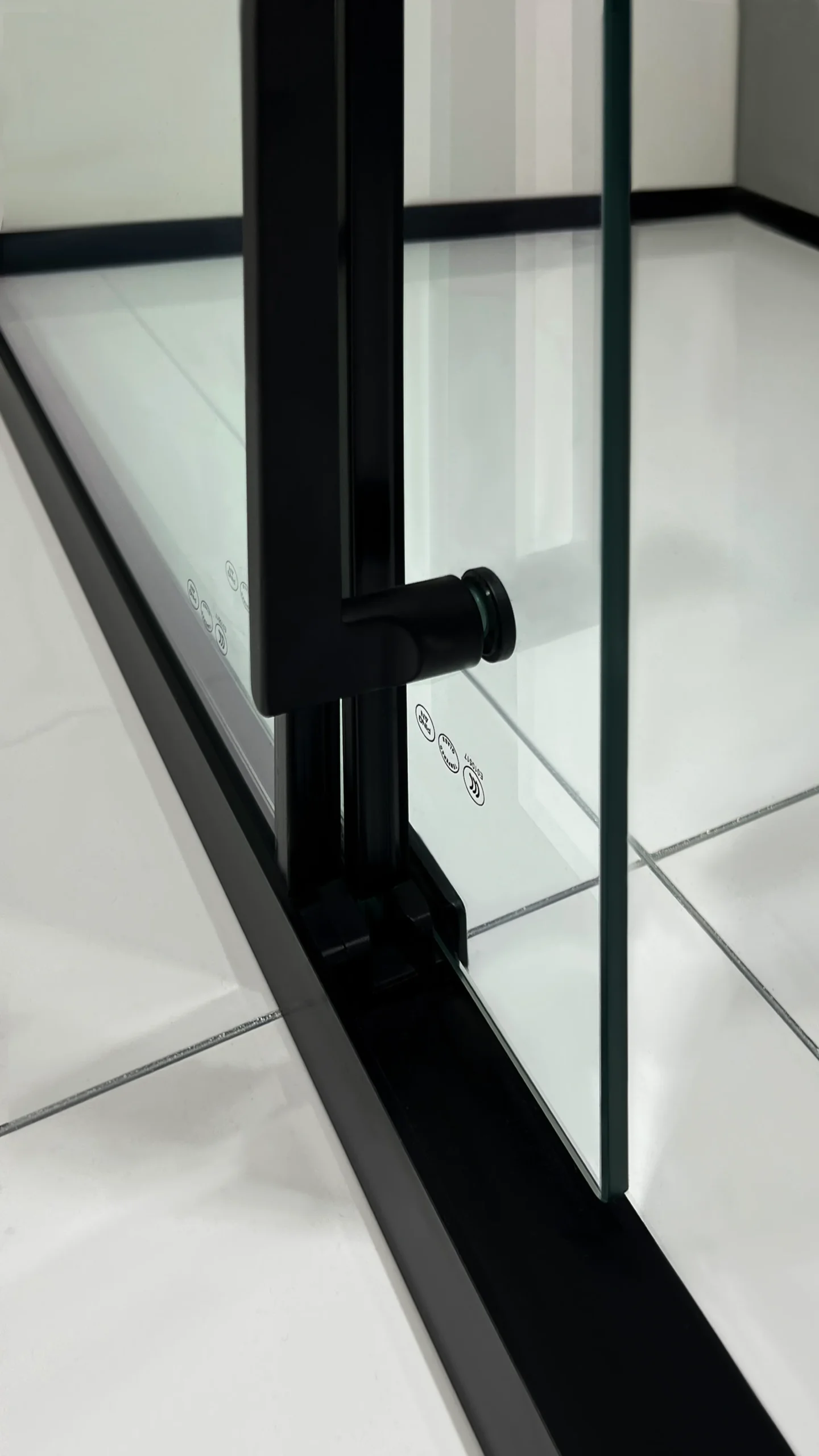 Matte black 3-panel sliding shower door with smoked glass, soft-close dampers, reinforced clamps, and magnetic waterproof seal for safety and durability.