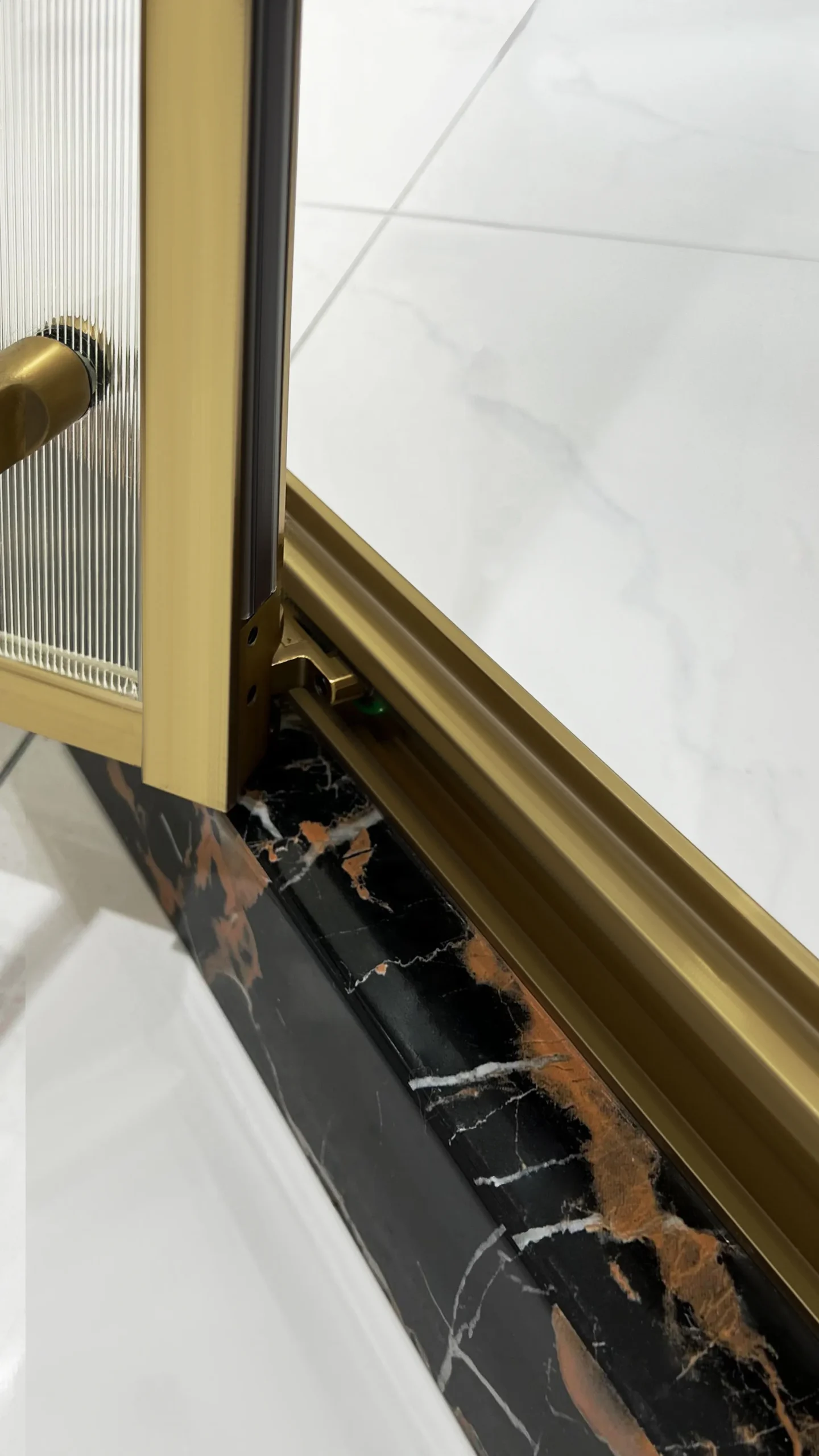 ZS15921 brushed brass neo-angle shower enclosure showing durable stone-composite base with groove design for secure, long-lasting water barrier. Select 79 more words to run Humanizer.