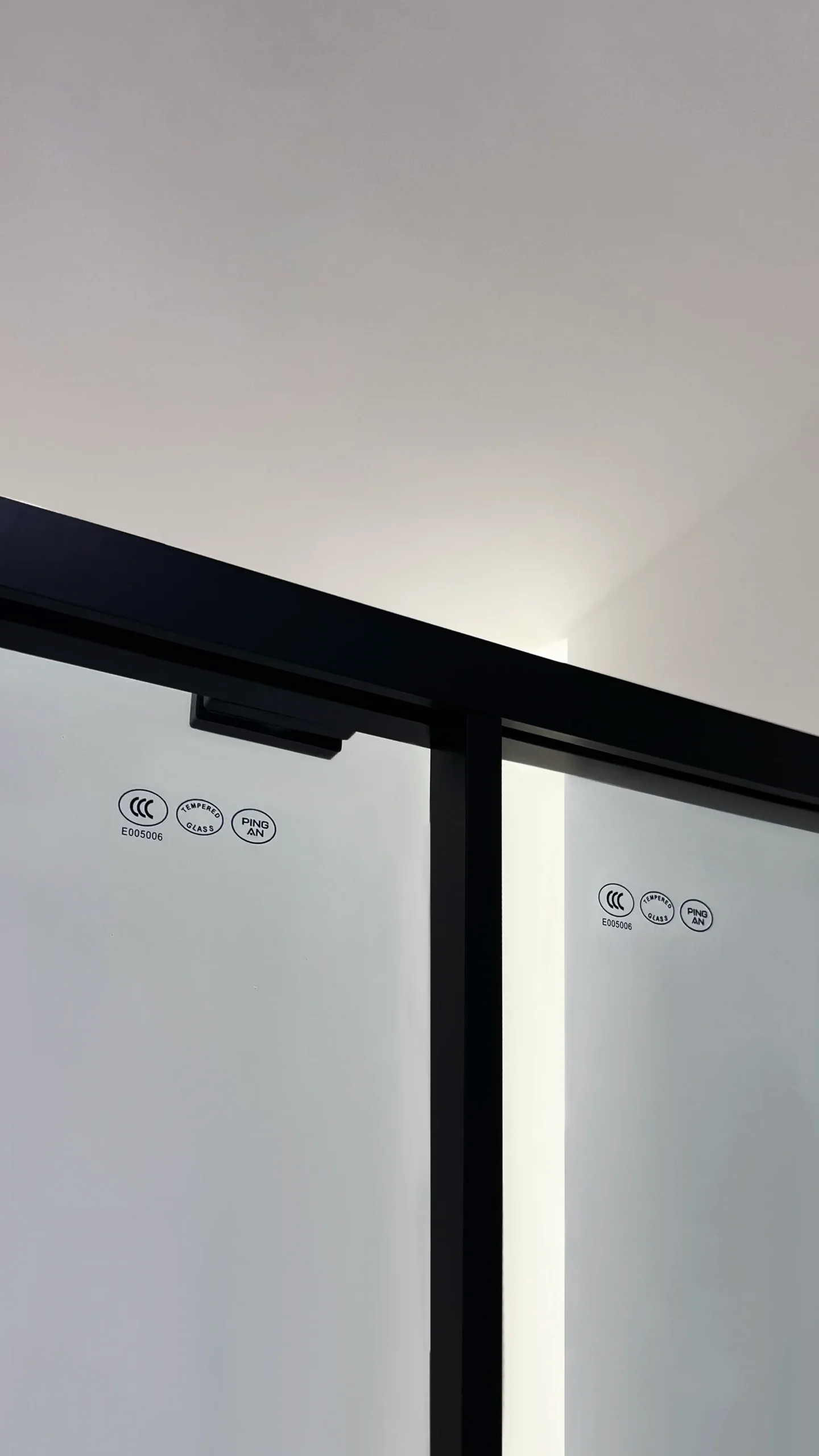 Matte black framed sliding glass shower door with fixed panel, highlighting 304 stainless steel top rail and ultra-slim 15mm frame for a clean, modern look.