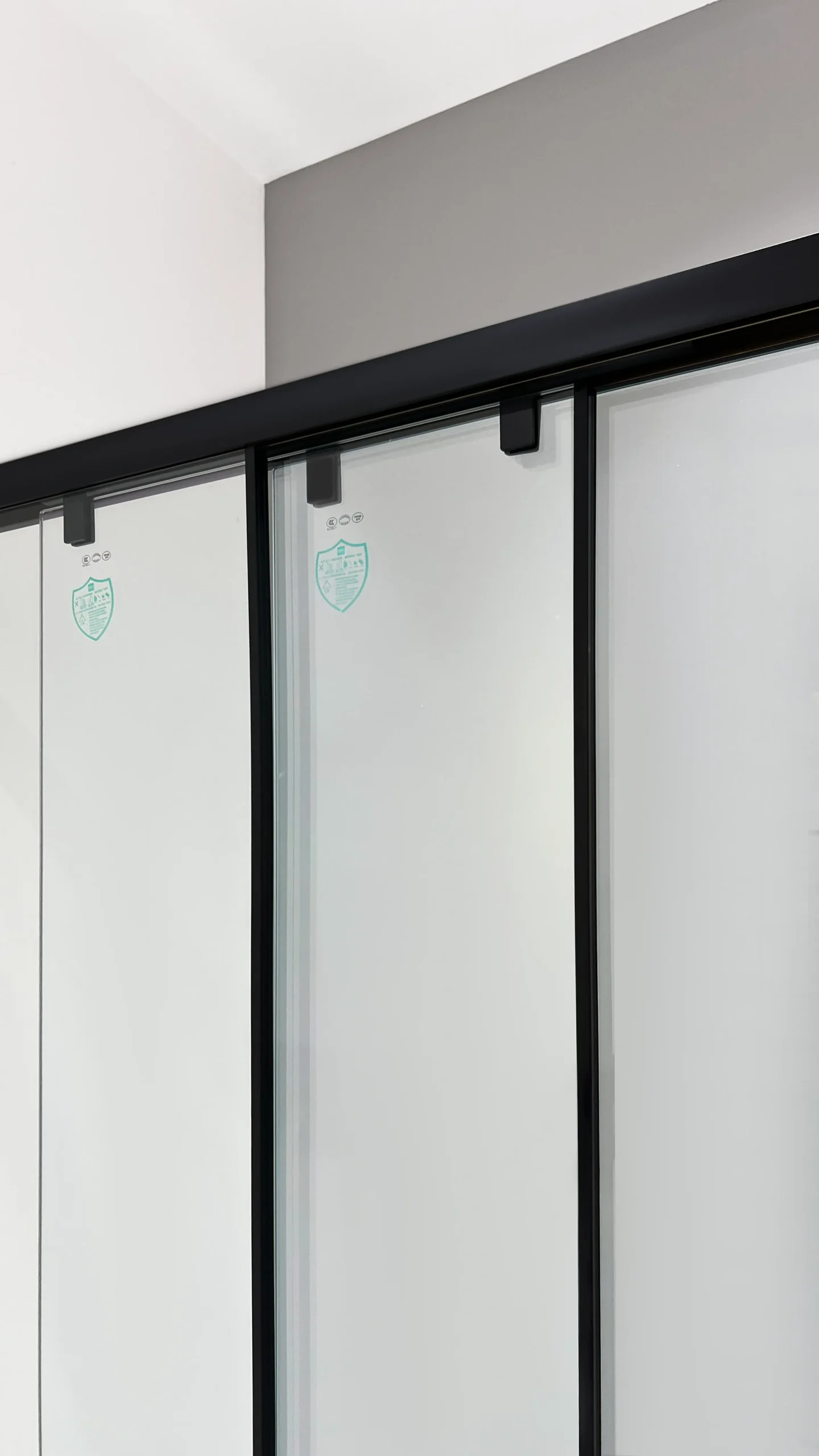 Matte black 3-panel sliding shower door with smoked glass, triple-track design, and 304 stainless steel frame resisting corrosion for long-lasting durability. Select 76 more words to run Humanizer.