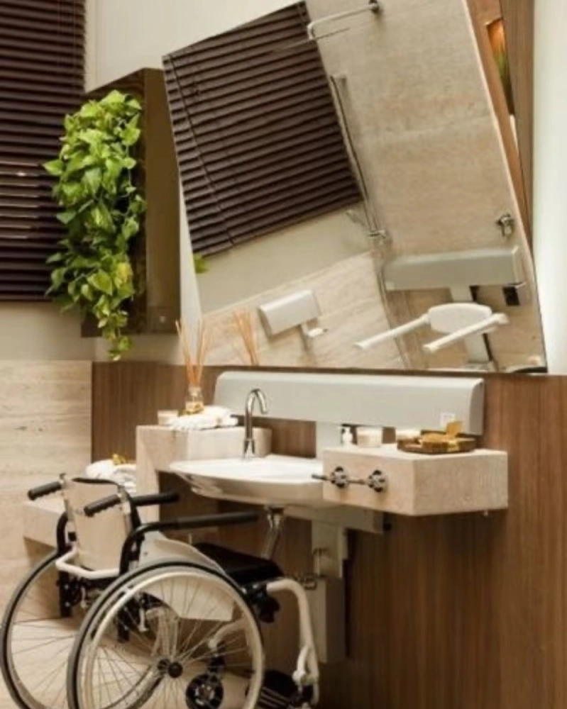 Custom-designed accessible vanity unit with knee clearance for wheelchair users, luxury wood finish for hospital VIP suites.