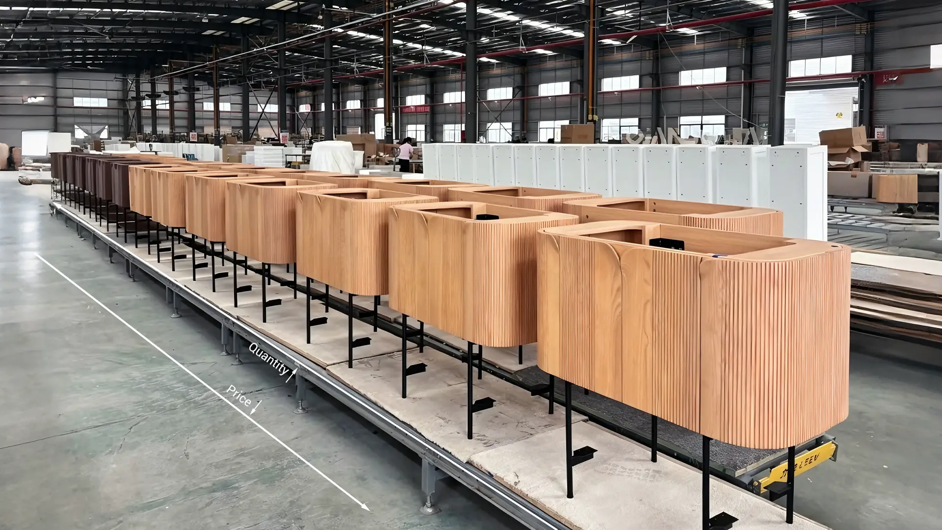 Fluted wood hotel vanities in a factory production line, demonstrating volume pricing for large-scale hospitality projects.