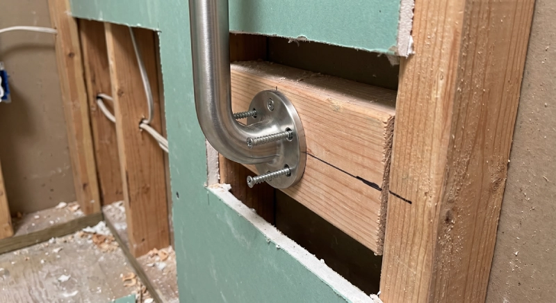 ADA shower grab bar installation with wall reinforcement and blocking detail