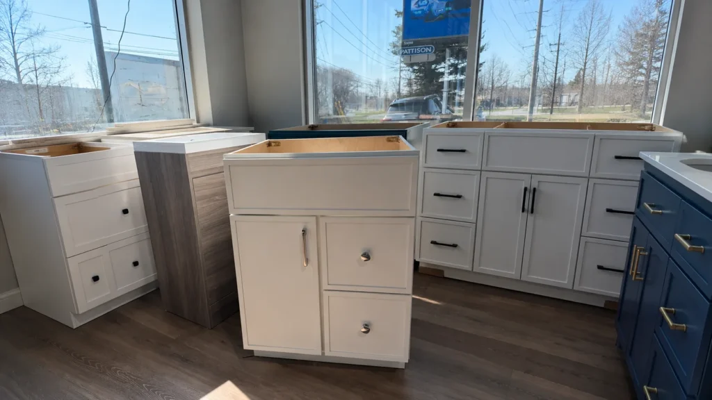 White and navy Shaker bathroom cabinets in a showroom for inspecting door structure, finishes, and hardware for projects.