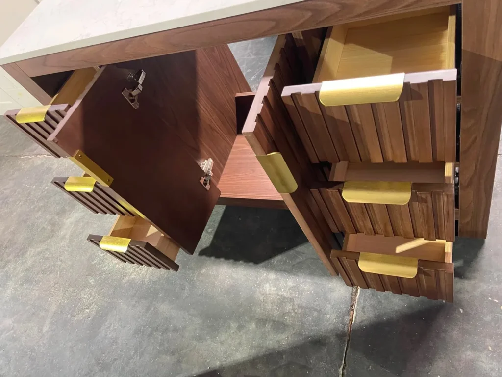 Walnut fluted bathroom cabinet with gold handles, shown with open drawers to inspect hardware and finish consistency.