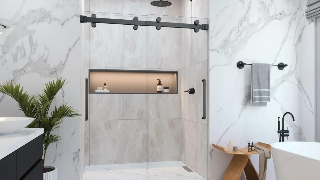 Modern frameless sliding glass shower door with matte black rollers and hardware installed in a luxury hotel marble bathroom.